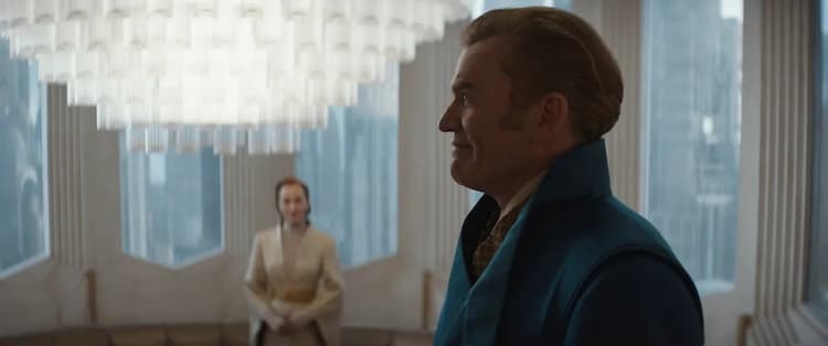 The well-dressed banker looks around Mon Mothma's lavish home while she stands in the background.