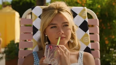 Alice sits looking well-groomed and relaxed in a beach chair sipping a cocktail.