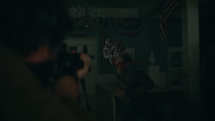 Joel aims a gun at a Clicker