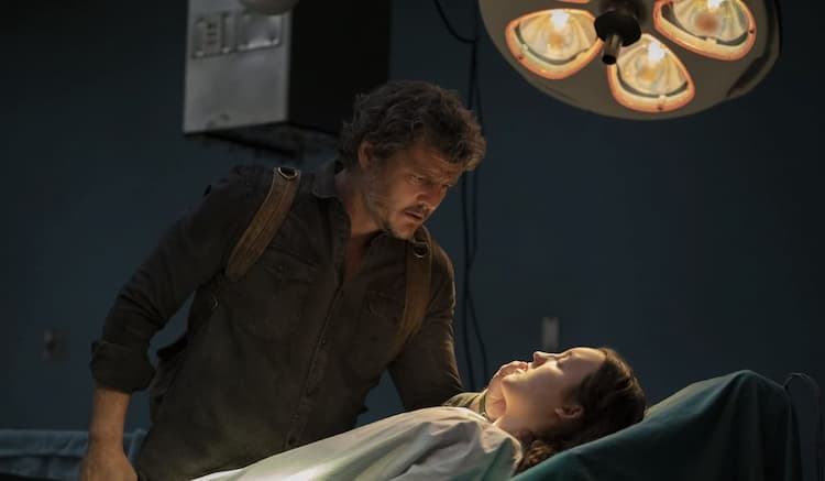 Joel looks over a sedated Ellie in the operating theatre