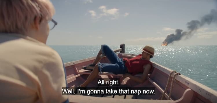 Luffy goes to sleep on a small boat with a ship wreckage behind them
