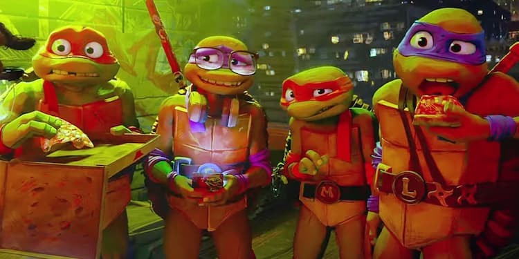 Raphael, Donatello, Michelangelo, and Leonardo are standing on a rooftop, eating pizza. Donatello is on his phone, and all of them look confused