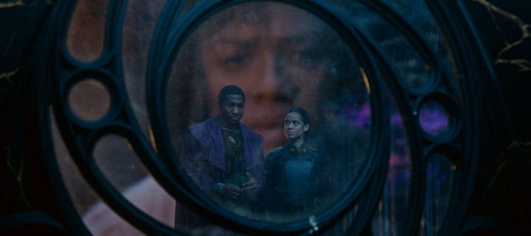 Renslayer is watching a miniature recording of herself and He Who Remains. They are staring out a circle window. Renslayer's face can be seen behind them.