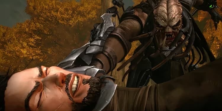 The Ninja Predator is holding Kenji by the throat with his right hand. The Predator is screaming at Kenji. Kenji has a distressed look on his face. Brown trees are in the background.