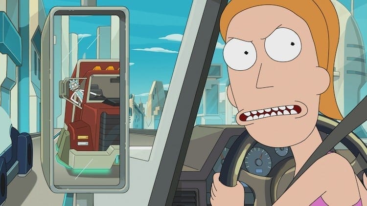 Summer is looking angrily back towards the camera. She is driving a truck. In the side mirror, we can see Rick driving a different truck.