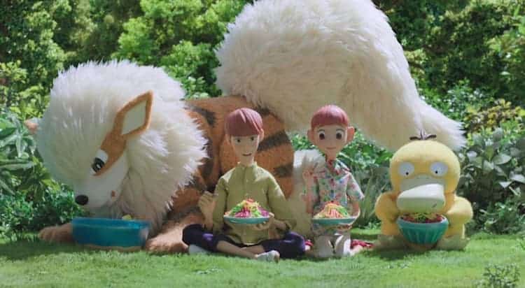 Haru, Kent, Psyduck, and Arcanine are eating food together during the day. All four of them are looking at their food.