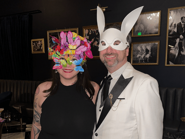 Two people in masks that did NOT win the costume contest