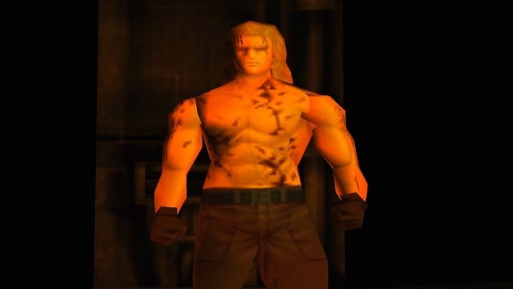 Liquid Snake has no shirt on and is standing in the centre of the shot.