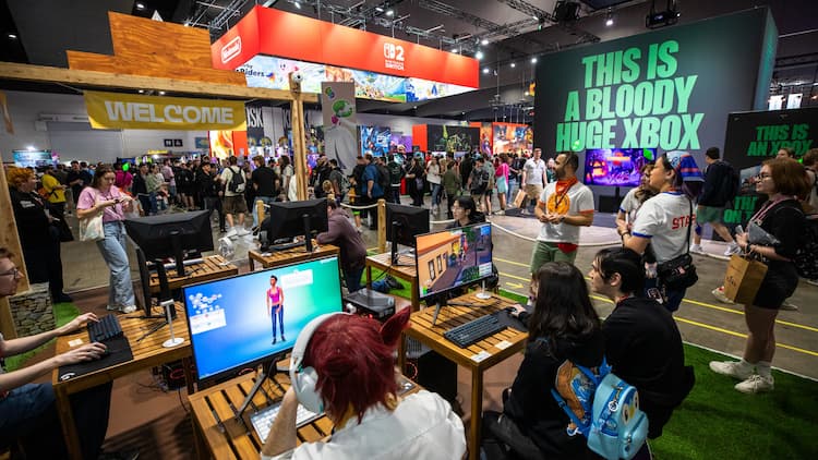 The Sims, Xbox, and Nintendo booths on the expo floor at PAX Aus 2025. People are walking through the booths. They are playing games. The Xbox booth has "THIS IS A BLOODY XBOX" on the side.