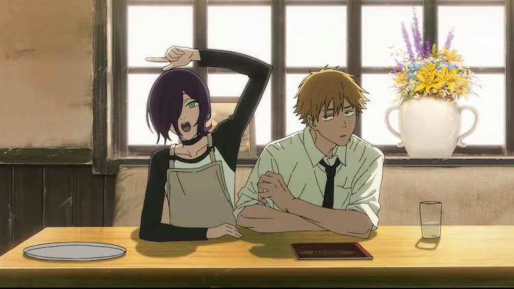 Reze and Denji are sitting at a table in a cafe. Reze is on the left, signalling with her left hand for someone to come over. Denji is on the right and is giving Reze a side-eye glare.