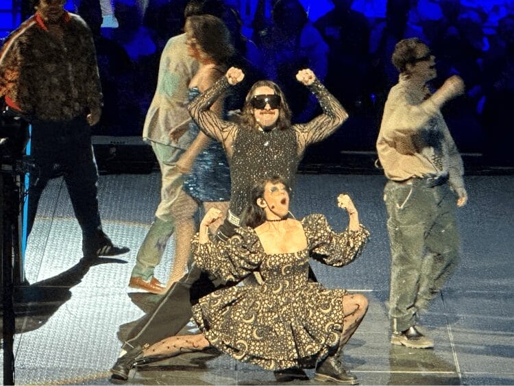 Emily Axford and Brian Murphy entering the stage for Viva Más Vegas