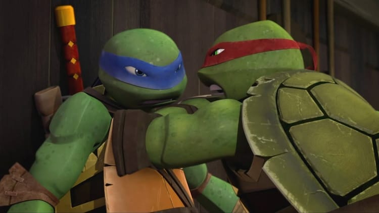 Raphael, right, has Leonardo, left pinned up against a wall.