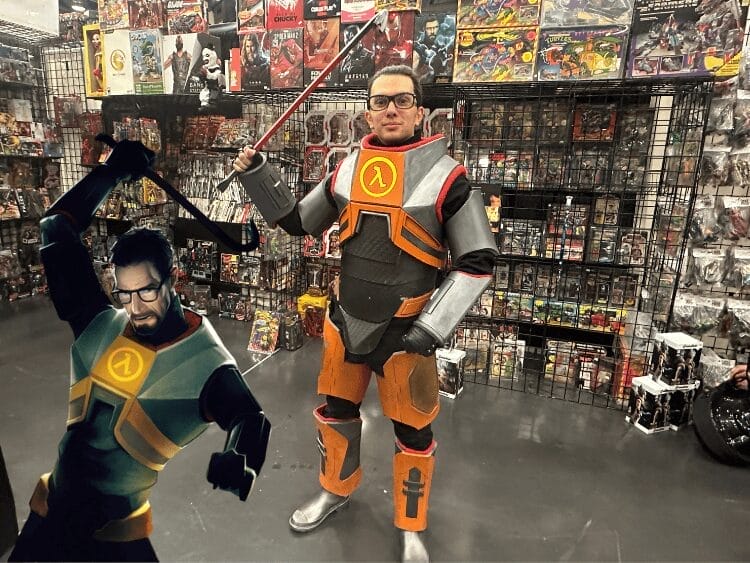Cosplayer as Dr. Gordon Freeman from Half-Life holding a crowbar in front of a toy booth