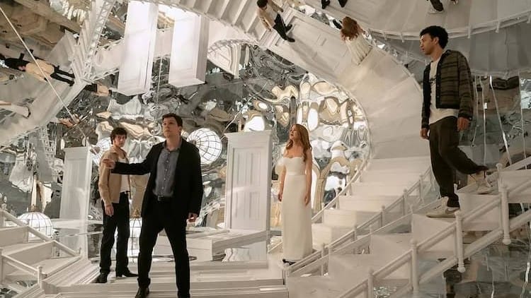 Bosco, Atlas, Henley, and Charlie are in a room covered in mirrors. Their reflections are covering the room. Atlas is looking at something in the distance.