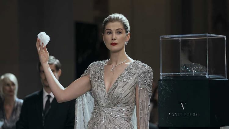 Veronika is holding the Heart Diamond in her right hand. She is standing next to the box where the diamond was held. She has a stern look on her face. One of her bodyguards is behind her.