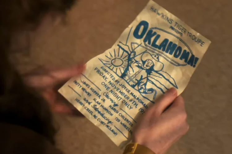 Max is holding a flyer for Oklahoma!