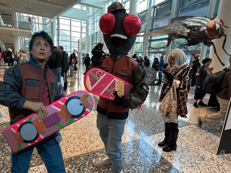 A cosplay with the clothes of Marty McFly from Back to the Future plus a massive handmade fly head