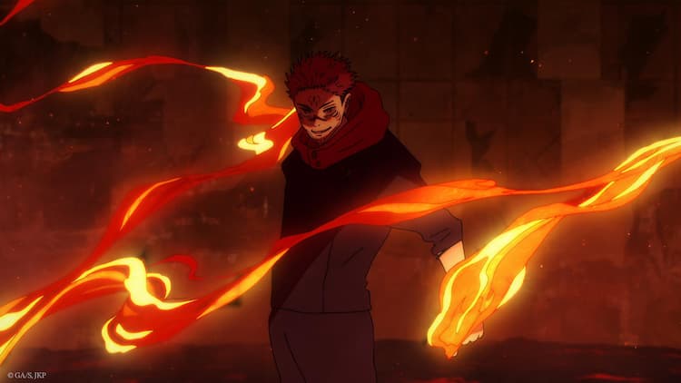 Sukuna is standing in the middle of a destroyed Shibuya. Destroyed buildings are in the background. Flames are circling around Sukuna and are coming from his left hand.