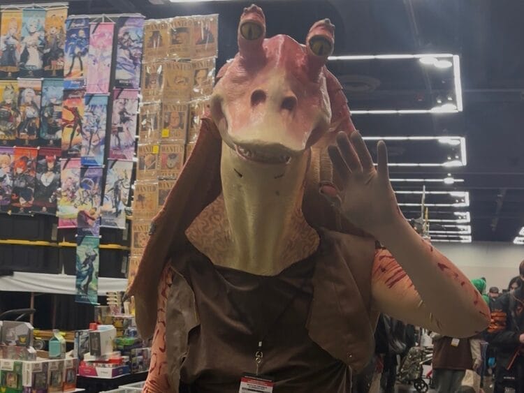 A cosplayer is dressed as Jar Jar Binks.