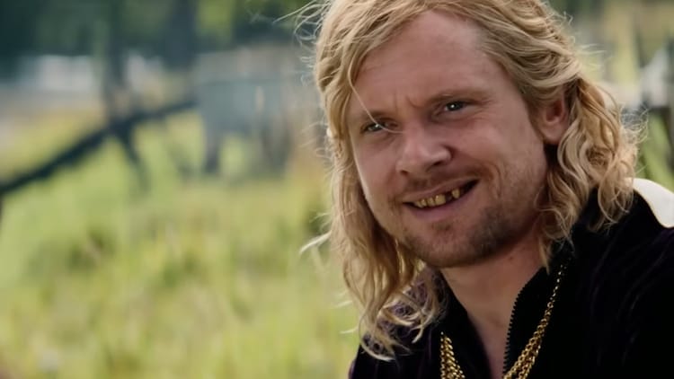 Sir Jimmy Crystal is smiling towards the camera.